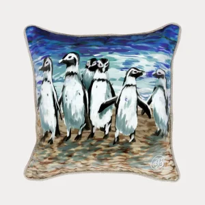 A square Cushea Cushion featuring bold, impressionistic artwork of African Penguins standing together on the beach with a blue ocean backdrop.