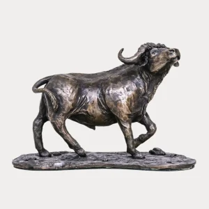 Bronze sculpture of a solitary Cape buffalo bull, head raised and body detailed with muscular form, mounted on a textured bronze base.