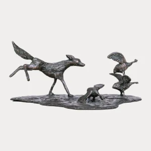 Bronze sculpture of a black-backed jackal chasing a flock of guinea fowl, captured mid-stride with dynamic movement.