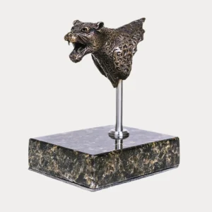 Bronze leopard bust sculpture with open mouth, mounted on a polished stone base, angled view.