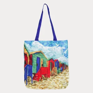 Colorful Muizenberg beach huts printed on a vibrant Totelier tote bag with blue handles.